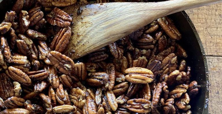 Sweet and spicy pecans coated with brown sugar and warm spices in a skillet